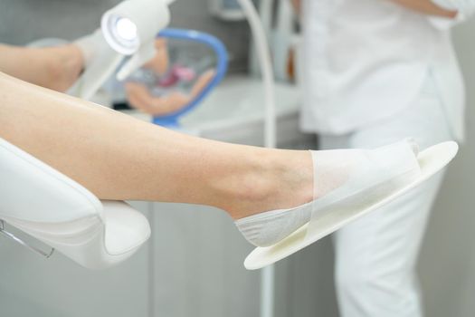 patient laying in gynecology chair in a gynecologist office