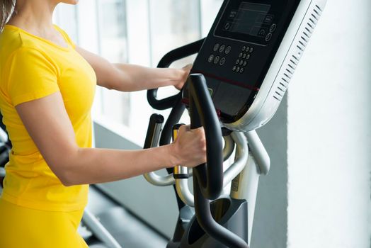 Gym: Woman Working Out On Elliptical Machine