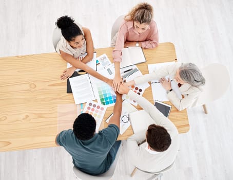 Diversity, top view of colleagues hands stack and planning in meeting at office. Hand together for collaboration or teamwork, brainstorming or goals and group with motivation, strategy and support.