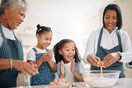 Grandmother, mom or excited children baking in kitchen as a happy family with young girl learning a recipe. Cracking eggs, clapping or grandma smiling or teaching kids to bake a cake for development.