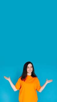 Smiling Young Woman Holding Empty Copy Space in Palms, Attractive Female Model, Isolated on Bright Blue Background, Portrait Photo.