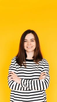Vision Health Promotion: Positive and Stylish Woman Advocating for Ophthalmology Checkup - Eye Care Awareness Isolated on Vibrant Yellow Background.