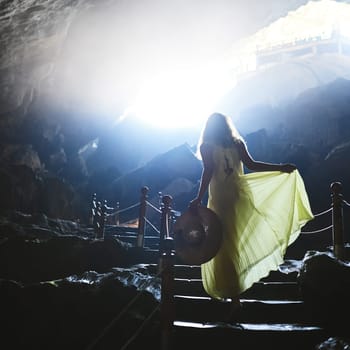 In darkness, let your soul light the way. a young woman walking up steps in a Vietnamese cave