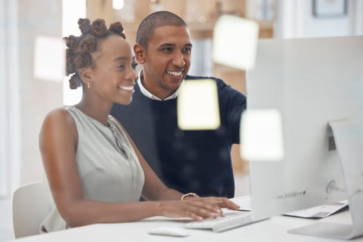 Collaboration, colleagues working together and at computer in their modern workplace office. Teamwork or partnership, support or and mentor with coworker at her pc typing with help at workstation.