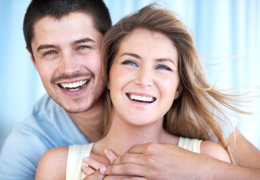 Laughing together brings them closer. Cropped head and shoulders shot of a happy and attractive young couple