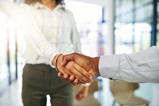 Starting off a new business venture. Closeup shot of two businesspeople shaking hands in an office