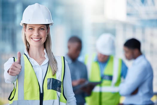 Portrait, thumbs up and a woman construction worker outdoor on a building site with her team in the background. Management, thank you and support with a happy female architect outside for motivation.