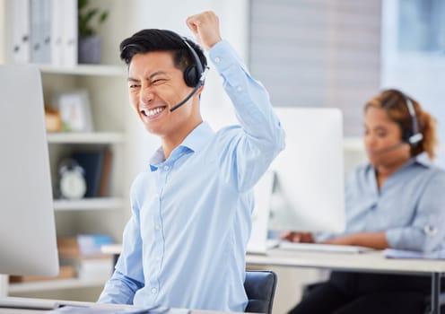 Telemarketing, business man and success cheer of staff with good news and promotion email. Motivation, contact us and call center Asian employee with fist and winner gesture in office with support.
