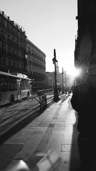 sky,atmosphere,bus,black,lighting,building,standing,sunlight,monochrome,snapshot,street,town,transport,white