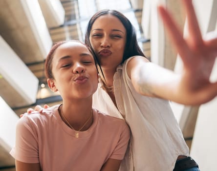 Peace, kiss and pout with black woman friends in the city together, posing with a hand sign or gesture. Happy, smile and bonding with a young female and her best friend in an urban town from below.