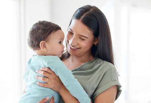 Smile, mother and holding baby in home for love, care and quality time together for childcare, development and growth. Mom carrying infant kid, newborn girl and support of comfort, bond and happiness.