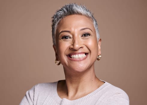 Black woman, beauty and smile in studio for senior skincare, cosmetics or fashion on brown background for health, wellness and motivation. Face portrait of mature model with perfect teeth and skin.