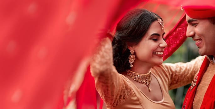 Happy Indian couple, wedding and smile for love, compassion or romance together with care and joy. Hindu man and woman smiling in joyful happiness for marriage, tradition or red culture celebration.