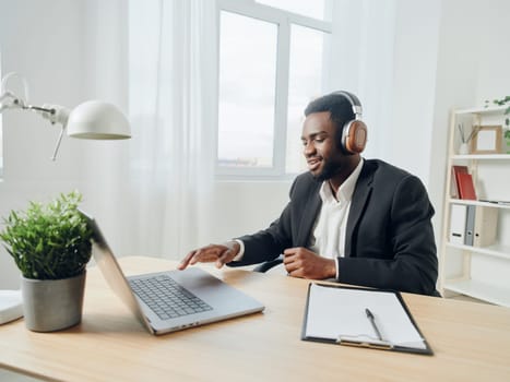 man african cyberspace online learning call lesson american laptop distant education computer language student headphone african-american learn music class video distance work