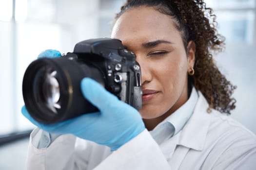Camera, photography and medical with black woman in forensics laboratory for investigation, crime scene and evidence. Research, analytics and observation with girl and digital pictures for science.