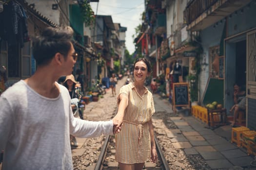 Fill your life with fun memories. a young couple walking through the streets of Vietnam