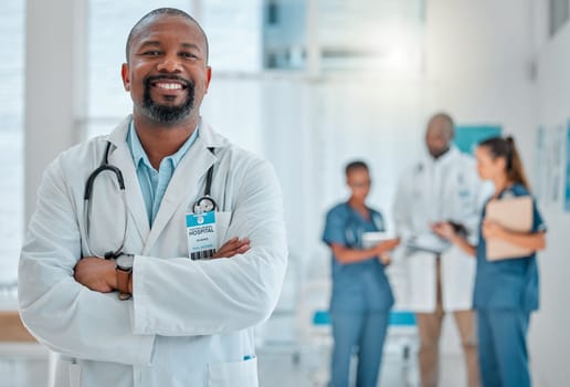 Happy, doctor and portrait of black man with crossed arms for medical help, insurance and trust. Healthcare, hospital team and face of professional male health worker for service, consulting and care.
