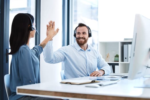 High five, callcenter team and contact us, phone call success and people celebrate in office. CRM, communication and solidarity in customer service, man and woman help desk consultant with motivation.