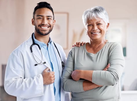 Happy portrait, doctor and senior patient for healthcare, retirement wellness and hospital service. Smile, face and Biracial elderly woman with medical professional, worker or asian person for health.