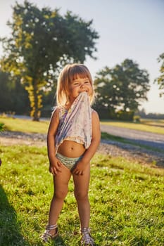 Adorable child playing in the hot summer in the garden in Denmark.