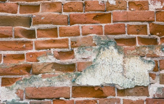 Brick wall from the old historical architecture. A wall damaged by time.