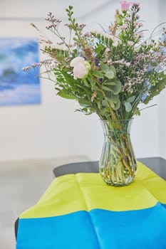 Wildflowers in a vase and Ukrainian flag.