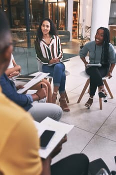 Coming together is a beginning, staying together is progress. a team of business people sitting together during a meeting