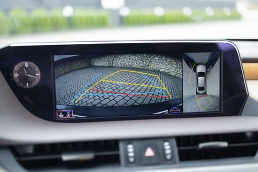 Surround view monitor. Front camera of circular 360 degrees view system. 360 terrain system in a modern car. Dashboard display screen with multimedia and 360 camera view in a new luxury vehicle.