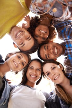 Happy, portrait and low angle of friends in circle with diversity, unity and collaboration. Teamwork, smile and group of multiracial people in huddle together for solidarity, community and friendship.