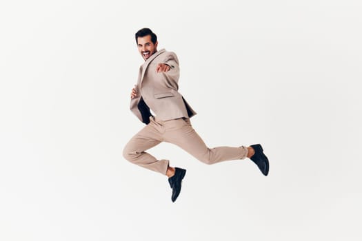 happy man professional suit attractive arm background tie copyspace flying beige jumping winner smiling running businessman young smile business victory isolated