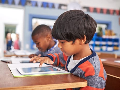 Learning technology from a young age. elementary school children using a tablet in class