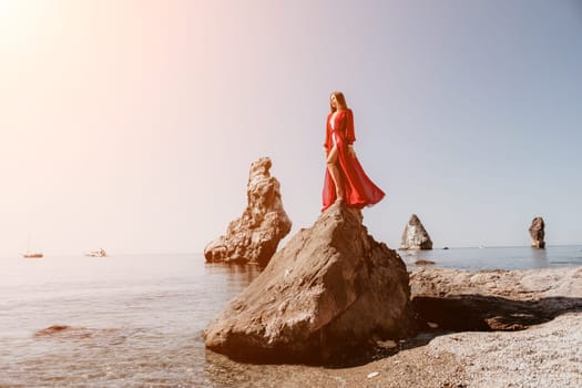 Woman travel sea. Happy tourist taking picture outdoors for memories. Woman traveler looks at the edge of the cliff on the sea bay of mountains, sharing travel adventure journey.