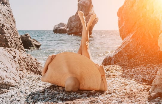 Woman travel sea. Young Happy woman in a long red dress posing on a beach near the sea on background of volcanic rocks, like in Iceland, sharing travel adventure journey