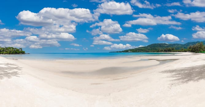 tropical paradise beach with blue sky and mountain panorama background.