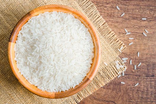Organic Thai Jasmine rice grain in wooden bowl preparing for cooked