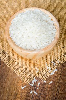 Organic Thai Jasmine rice grain in wooden bowl preparing for cooked