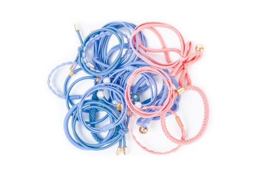 Heap of colorful fabric rubber bands. Elastic hair ties in vibrant colors on white background.