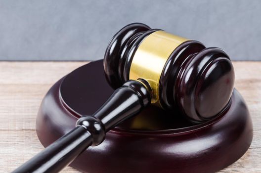 Judges gavel on wooden table.