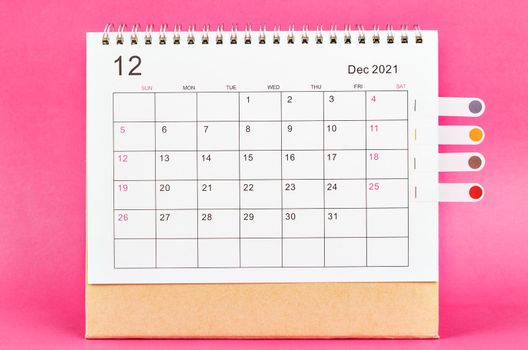 December 2021 calendar on pink background.