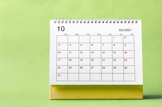 October Calendar 2021 on green background.