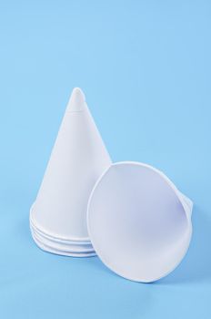 Disposable paper cone water cups water cups on blue background.