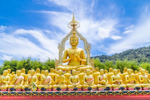 Row of disciple statues surrounding big buddha statue in public to the general public worship worship of Nakhon Nayok, Thailand.