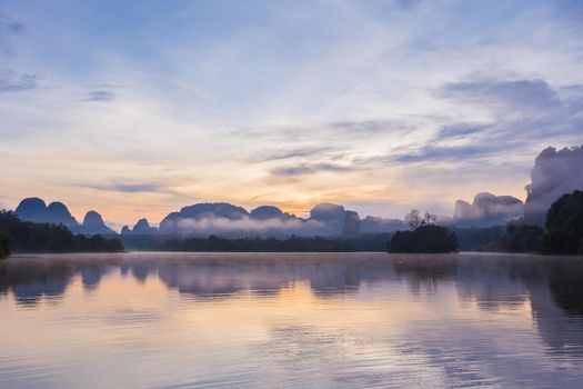 Ban Nong Thale the natural scenery of the sunshine in the morning (mountains, lakes, trees, fog) at Krabi, Thailand.