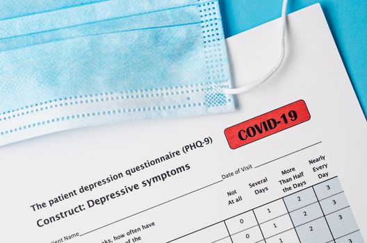 The patient depression questionnaire (PHQ-9) form for COVID-19 and Disposable face mask.