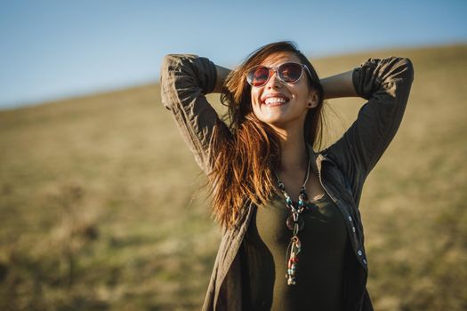 Shot of a smiling young woman enjoying the outdoors.