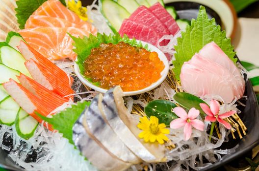 Close up ikura (salmon roe) in sashimi set, Japanese food style.