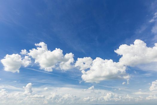 blue sky background with tiny clouds.