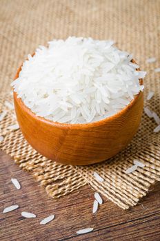 Organic Thai Jasmine rice grain in wooden bowl preparing for cooked