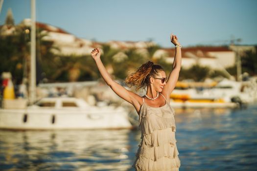 An attractive young woman enjoying a summer vacation while exploring the wonderful seaside of Meditteranian.