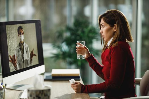 Shot of a young woman having a video call with a her doctor on a computer.